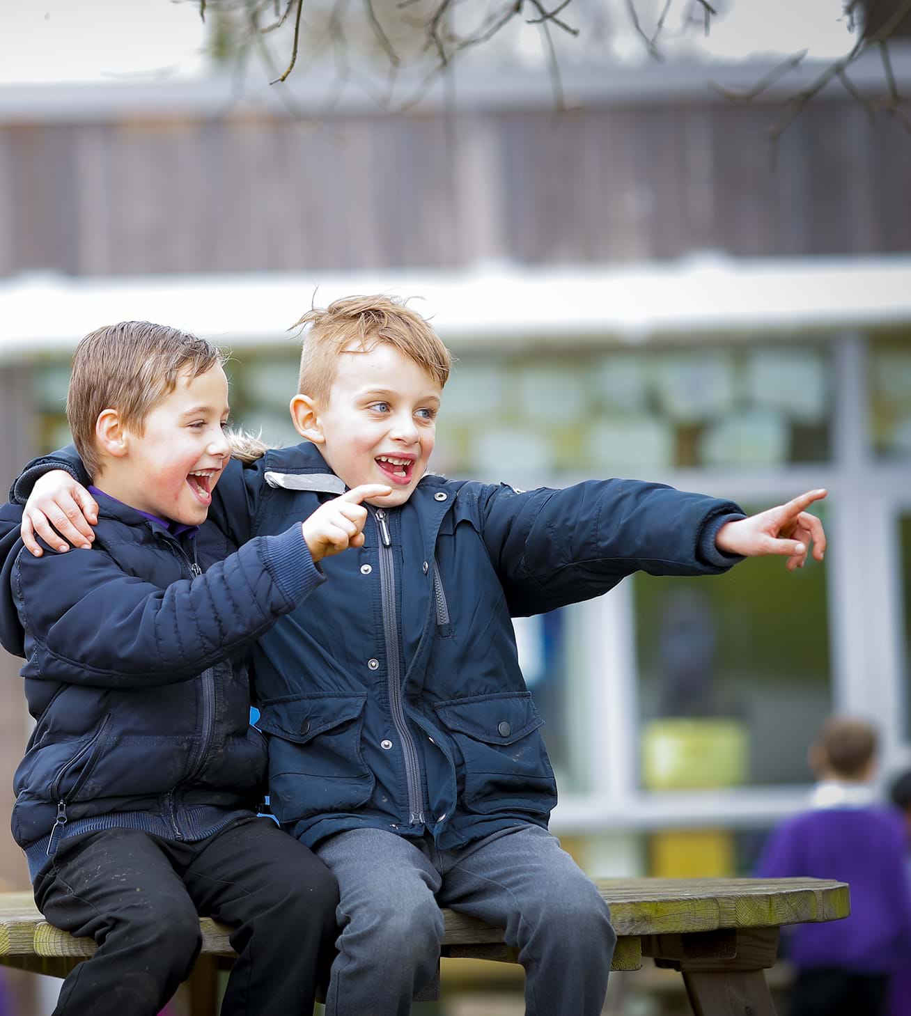 two boys smiling and hugging
